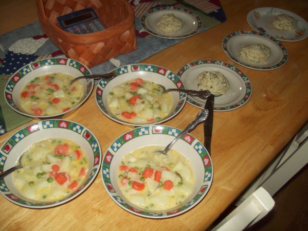 Potato soup with onions, carrots, peas & herb biscuits